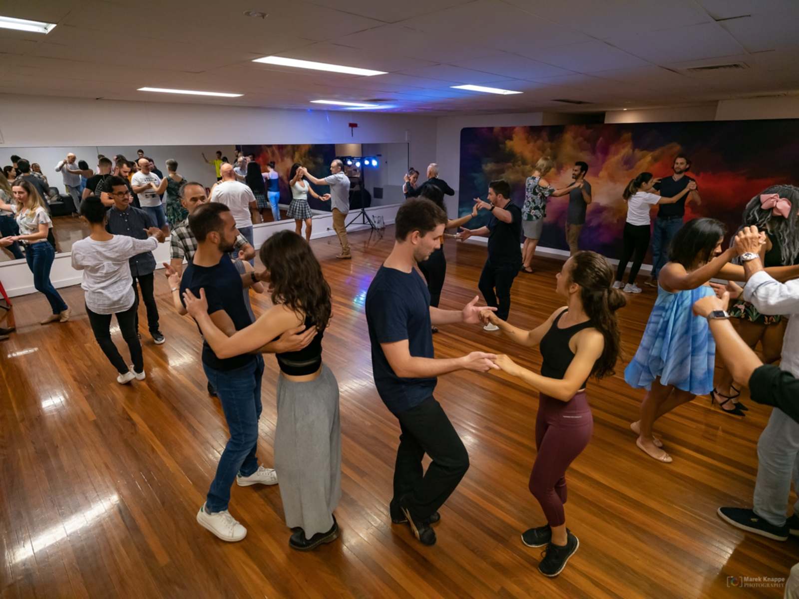 A full class of pairs dancing Salsa in the Dance Culture studio