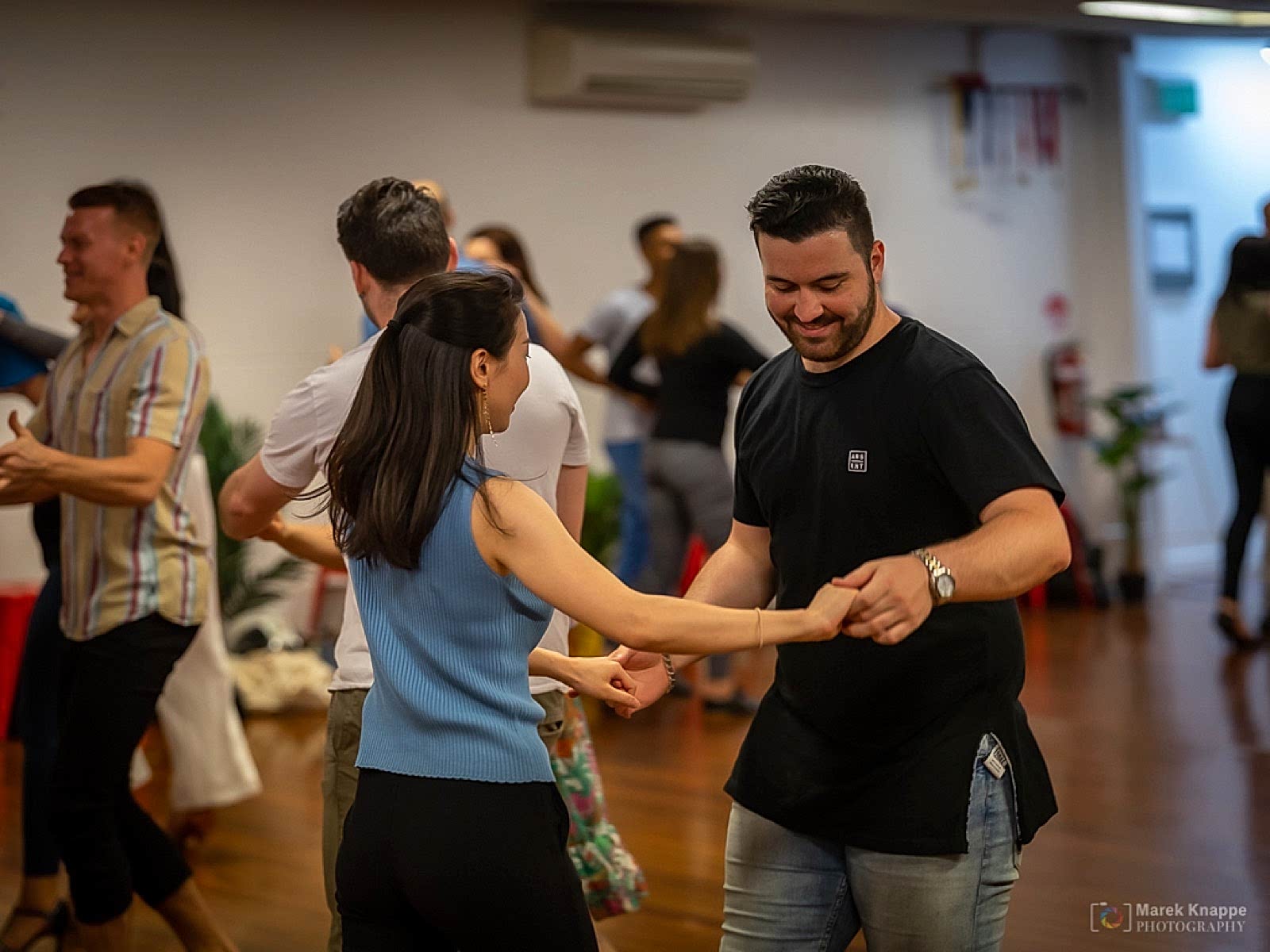 A couple dancing Bachata in low light