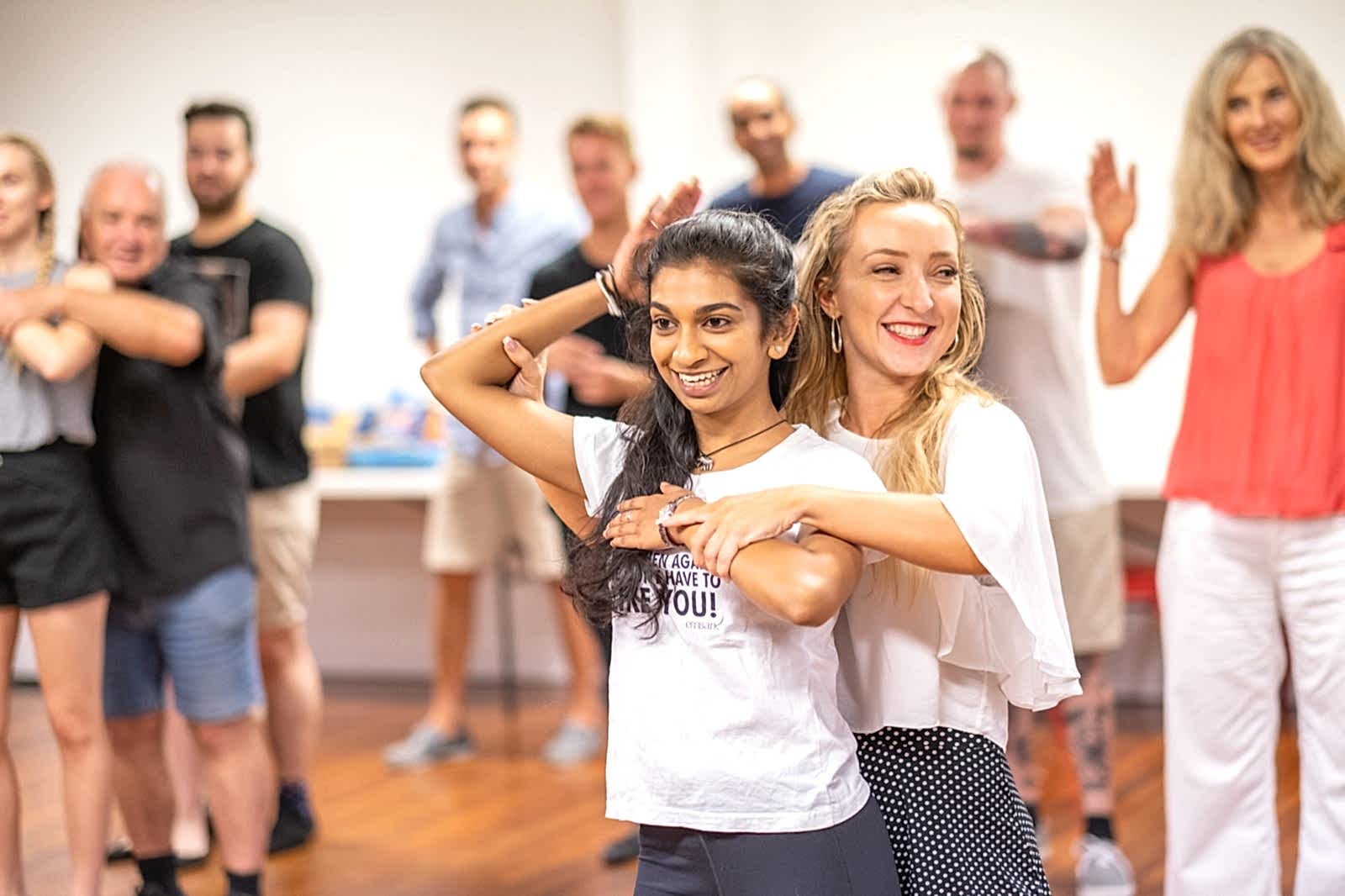 Students learning body movement and styling in class