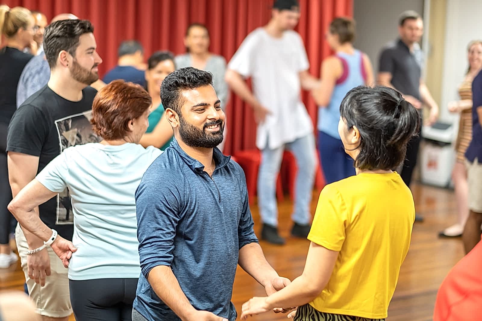 Students smiling as they rotate partners during class